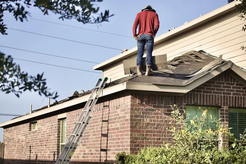 Professional roofer working on a residential roof in Waller